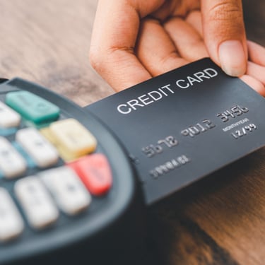 Person paying with credit card on card reader in the Dominican Republic, travel payment tips