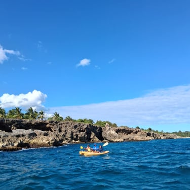 People kayaking on the Caribbean Sea near the rocky coastline of Boca de Yuma in the Dominican Republic