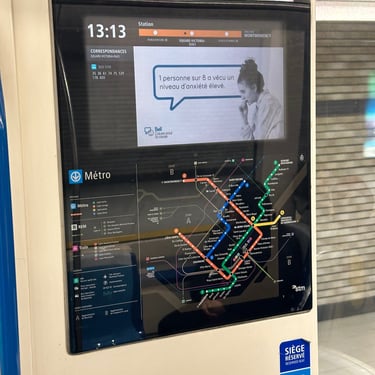 A digital screen on the Montreal Metro showing the system map and current location