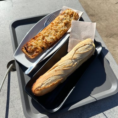 A flatbread and sandwich sitting next to each other on a plate