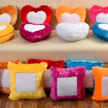 a couch with a bunch of pillows and a couch with a heart shaped picture frame