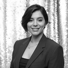 Black and white photo of a professional women wearing suit blue pen education consulting