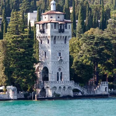 Torre San Marco reflected in Lake Garda, Gardone Riviera waterfront.