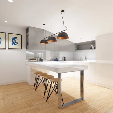 Centrally located island kitchen that acts as a dining table with bespoke pendant lights over