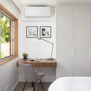 Interior design of the cozy bedroom in Mosman with white joinery cabinetry and a study desk