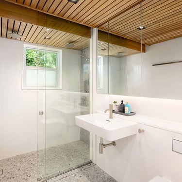 modern bathroom in Mosman with terrazzo flooring, victorian ash timber ceiling, large mirror and dual shower