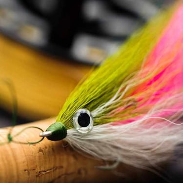 a fly fishing lure with a green and white fly
