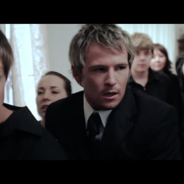A group of young people all dressed in black attending a wake