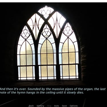 An arched stained-glass window set in shadowy church interior