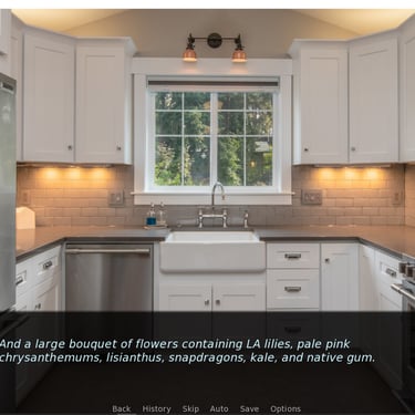 An elegant kitchen featuring white tiles and cabinetry, and stainless-steel appliances
