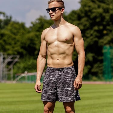 a man in a black and white shirt and sunglasses