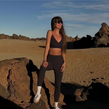 a woman in a black bra top and leggings