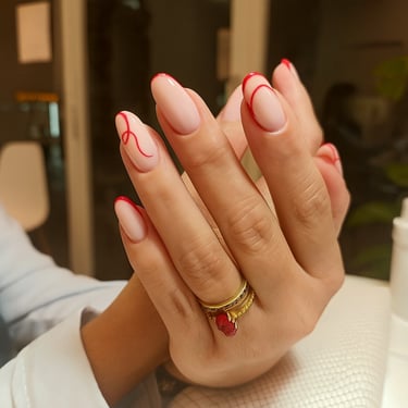 Uñas de gel con diseño abstracto de líneas rojas finas, estilo moderno y artístico en Móstoles