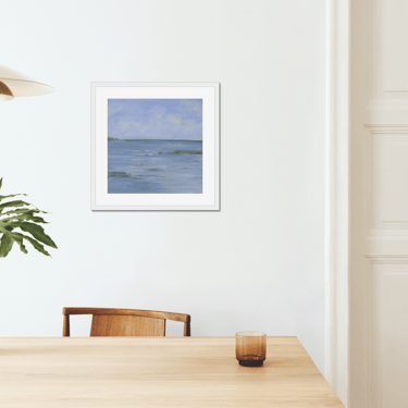 a table with a vase and a vase with a plant in it