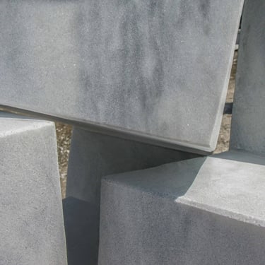 Detail of white marble with visible veining, meeting of different inclined planes.