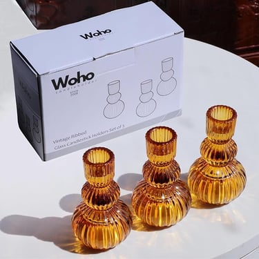 Set of three amber ribbed glass candlestick holders with box packaging labeled Woho