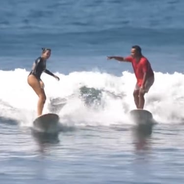 Ucup giving a surf lesson to Lise in Batukaras