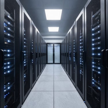 Symmetrical wide angle architectural shot of a modern data center corridor, rows of server racks with cool white indicator lights, clean metallic surfaces