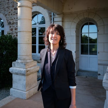Nadine Raimbault devant la porte d'entrée d'un domaine pour un mariage