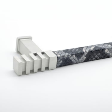 Photography case study featuring a cabinet pull with a leather wrap and silver metal finish.