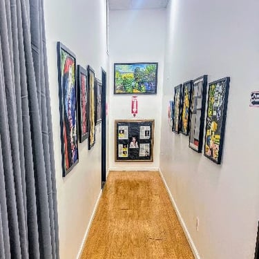 Long Hallway Adorned with Paintings: Evangeline Giron, Inc. Office