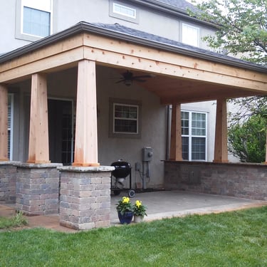 Paver patio with a custom cedar pavilion and granite bar top