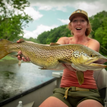 Angler with a 25" brown trout in Tennessee.