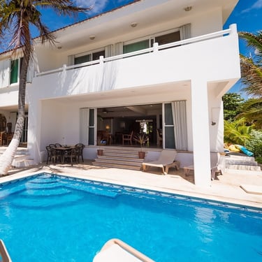 Beautiful exterior view of the retreat villa in Akumal, Mexico, surrounded by lush greenery, perfect for yoga retreats and me