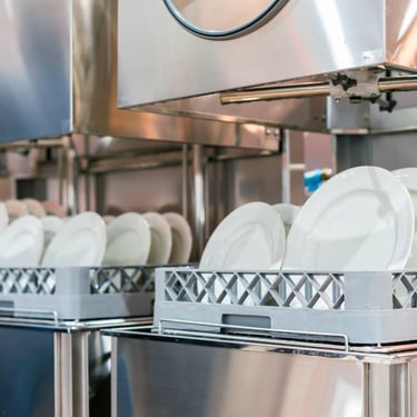 Commercial dishwasher loaded with plates, showcasing efficient cleaning equipment for restaurants and businesses