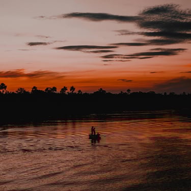 a couple of people in a boat on a river