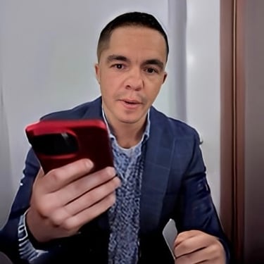 Cody Sechelski holding an red iphone, representing his growth into a faith-driven leader of multi-million-dollar construction