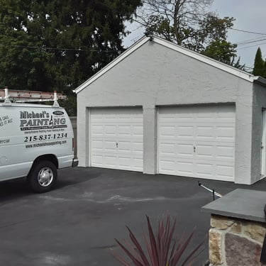 a van in the driveway and a garage