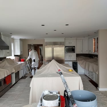 a man in a kitchen with a ladder 