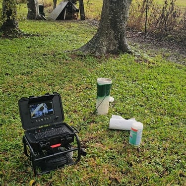 sewer camera in a field looking into a sewer system