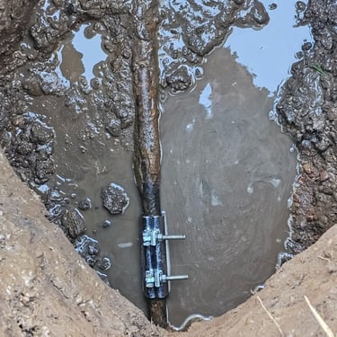 leak discovered in old steel pipe and a temporary fix put into place at Aurora area mobile home park