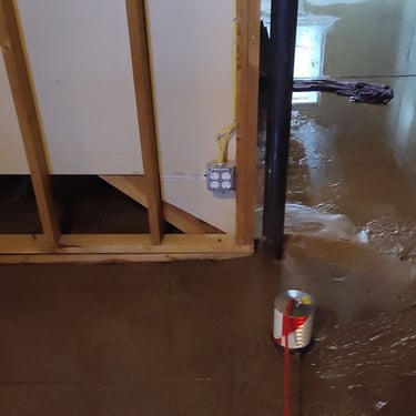 flooded basement with leak detection equipment on floor finding leak