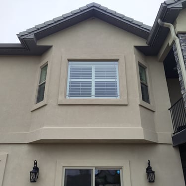 photo of a brown house with window leaks