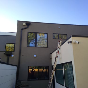 flat roof inspection ladder on side of the home