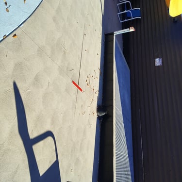 pool deck with red tape marking a leak