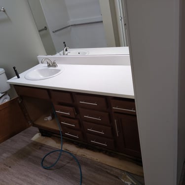 injecting tracer gas into the plumbing of a bathroom at a residential home