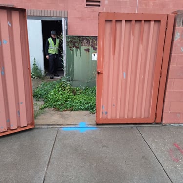 leak marked in blue paint outsite of commercial building