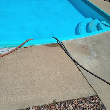 swimming pool with hoses running into the shell