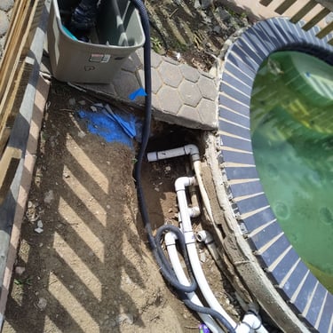 in ground hot tub with plumbing exposed