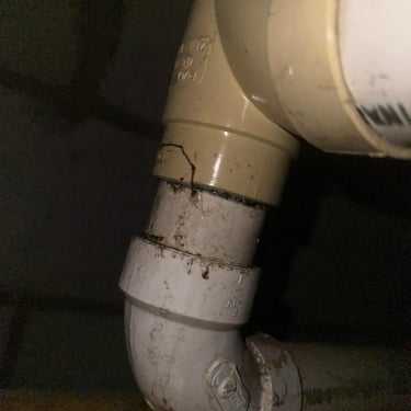 broken drain line with fluid leaking out