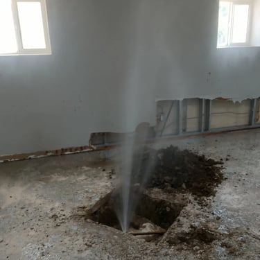 leak spraying out of the floor