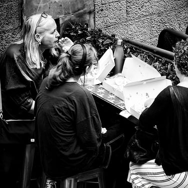 Three women enjoying their fish and chips on Victoria Street, Edinburgh