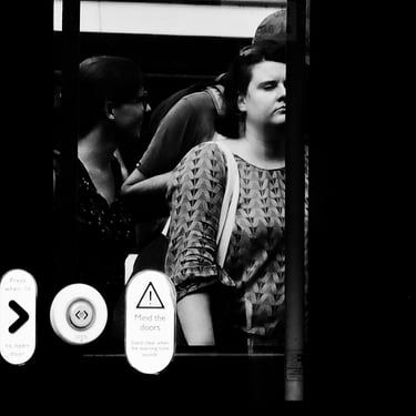 A woman seen through the window of a newly arrived tram. Princes Street, Edinburgh