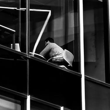 A man sits at a desk in an office, several floors up at Port Hamilton, Edinburgh