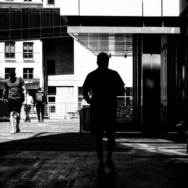 A man, in silhouette, walks down Ladyfield, off Morrison Street, Edinburgh
