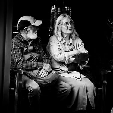A couple sit waiting for a bus in Morningside, Edinburgh